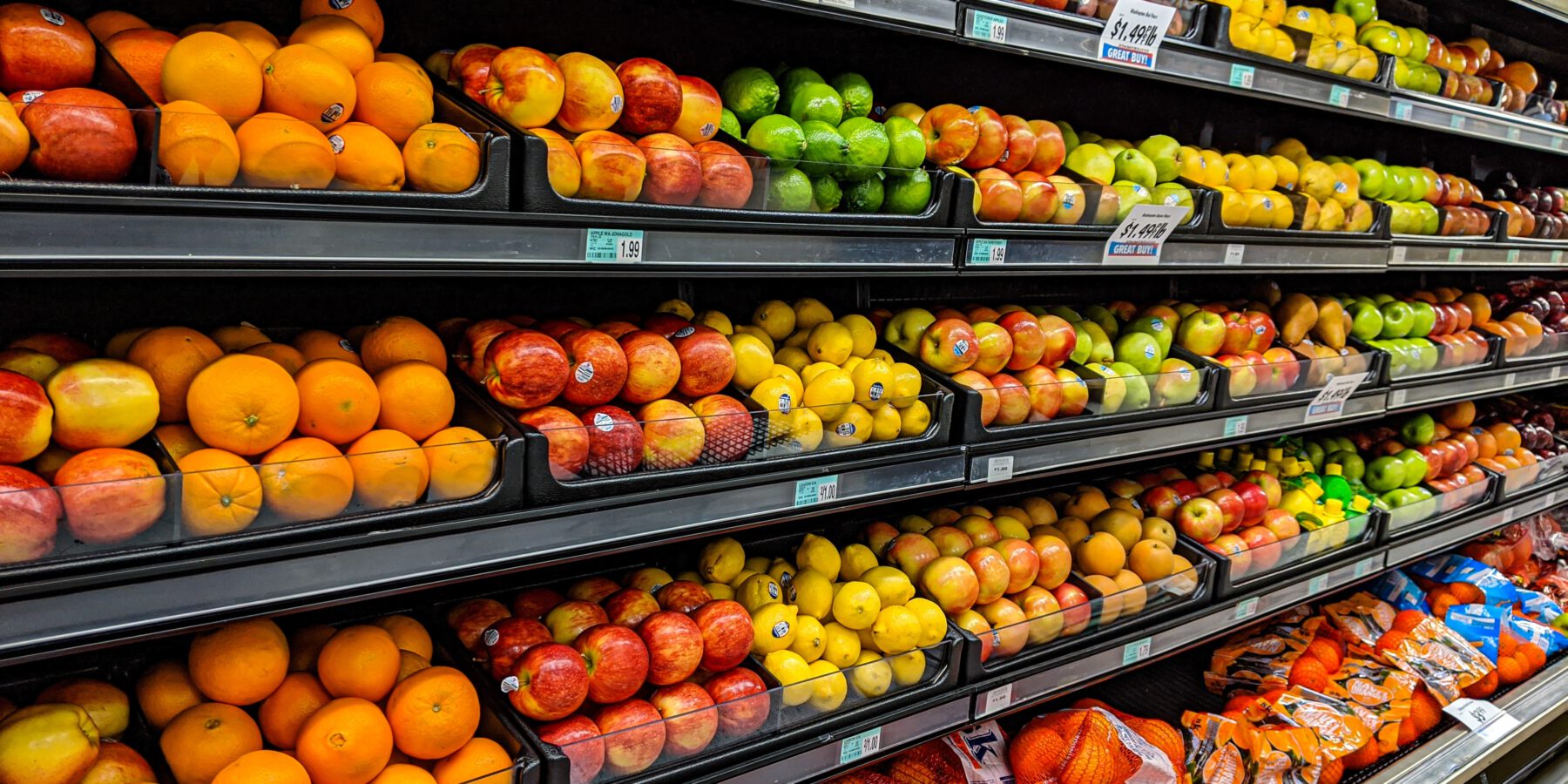 A selection of fruit in a commercial refrigerated produce case
